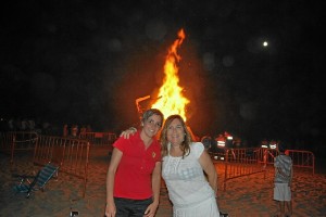 La Teniente de Alcalde y Concejala de Festejos, Isabel López, y la Concejala de Educación, María del Carmen Beltrán, al prender la hoguera.