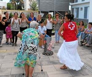 Una de las trabajadoras de la Cruz Roja de Isla Cristina bailando alrededor de la hoguera.