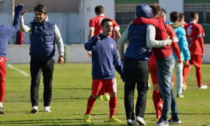 Aurelio Santos, entrenador de La Palma, celebra con sus jugadores el triunfo logrado en Valverde del Camino. / Foto: David Limón.