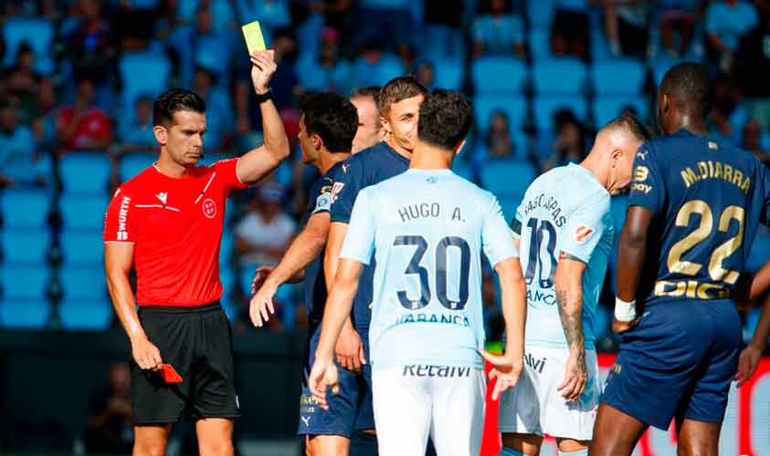 Alejandro Quintero muestra la cartulina amarilla a Iago Aspas, rectificando tras consultar en el VAR ya que previamente la había mostrado la roja. / Foto: www.lfp.es.